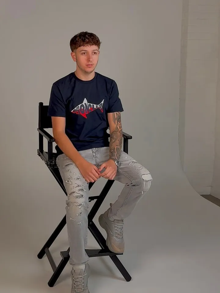 Kailan Watson, founder and CEO of WTSN Group, seated on a director's chair in a photo studio.